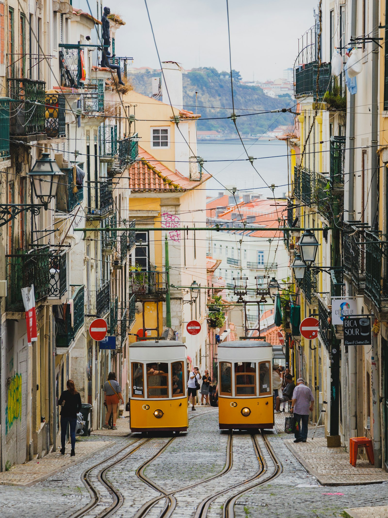Yellow tram on a steep Lisbon street